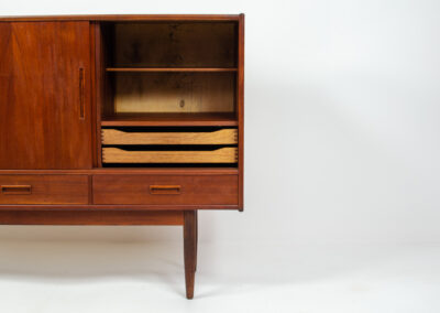 Danish sideboard in teak, 1960s. It contains 3 sliding doors, 3 drawers, lots of starage space and 2 drawers inside. In good condition with some traces of age.