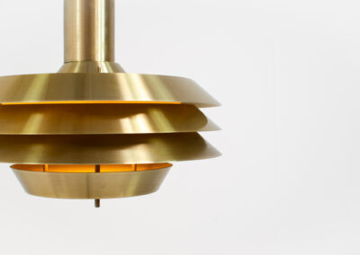 Brass colored Model 705 pendant light by Lyskaer (Denmark, 1970s).This space age beauty contains 4 aluminium shades with a brass colored exterior.Newly rewired and in very good condition.