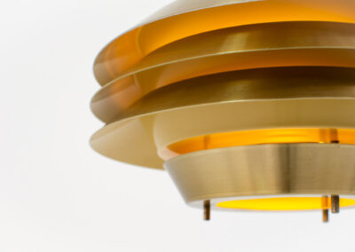 Brass colored Model 705 pendant light by Lyskaer (Denmark, 1970s).This space age beauty contains 4 aluminium shades with a brass colored exterior.Newly rewired and in very good condition.