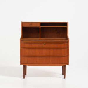 Danish secretary in teak, 1960s. A compact and multi functional piece that contains three main drawers, a small drawer on top, a mirror that flips out and a convenient pull-out leaf. In very good condition. Original key included.