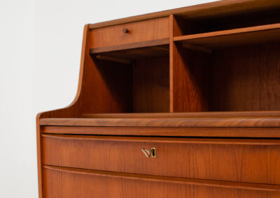 Danish secretary in teak, 1960s. A compact and multi functional piece that contains three main drawers, a small drawer on top, a mirror that flips out and a convenient pull-out leaf. In very good condition. Original key included.