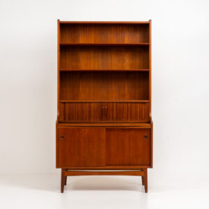 Teak bookcase/desk by Johannes Sorth for Borholms Møbelfabrik (Denmark, 1960s). A well-known and super multi functional design with a high quality standard. Featuring two sliding doors with lots of storage space inside, a convenient pull-out leaf, super detailed tambour doors with some storage space and drawers inside and two adjustable shelves. In very good condition with one repair spot on the right corner. Tambour doors open very smoothly. Marked by maker.