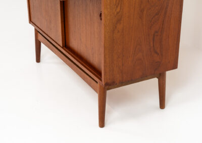 Teak bookcase/desk by Johannes Sorth for Borholms Møbelfabrik (Denmark, 1960s). A well-known and super multi functional design with a high quality standard. Featuring two sliding doors with lots of storage space inside, a convenient pull-out leaf, super detailed tambour doors with some storage space and drawers inside and two adjustable shelves. In very good condition with one repair spot on the right corner. Tambour doors open very smoothly. Marked by maker.