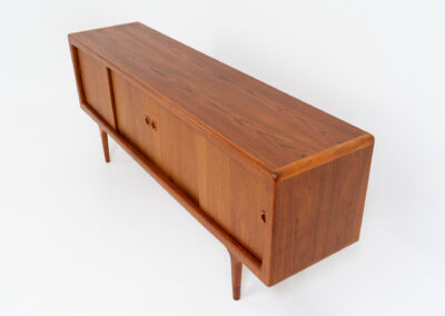 Stunning Danish sideboard in teak, 1960s. This piece is absolutely gorgeous! We are not sure who designed it, but it is referred to “K.L. Dansk” online. It’s extremely detailed and built to very high quality standards. It features four sliding doors with adjustable shelves and three drawers inside. The rounded edges and organic shapes on this piece are just amazing. In perfect condition!