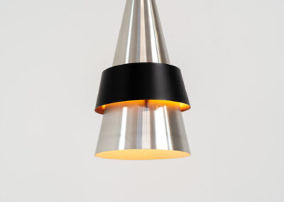 “Corona” pendant light by Jo Hammerborg for Fog & Mørup (Denmark, 1960s). If there’s an opposite of boring, this lamp is definitely it! Made out of brushed aluminium with a black halo, the black ring is lacquered in purple on the inside. In very good condition!