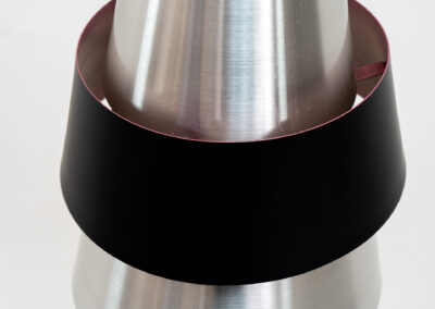 “Corona” pendant light by Jo Hammerborg for Fog & Mørup (Denmark, 1960s). If there’s an opposite of boring, this lamp is definitely it! Made out of brushed aluminium with a black halo, the black ring is lacquered in purple on the inside. In very good condition!