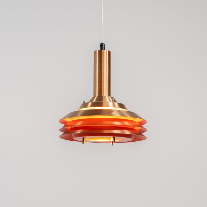 Copper plated Model 705 pendant light by Lyskaer (Denmark, 1960s). This space age beauty contains 4 aluminium shades with a copper colored exterior. The inside is lacquered in orange, which creates a beautiful and warm light dispersion. Newly rewired and in very good condition.
