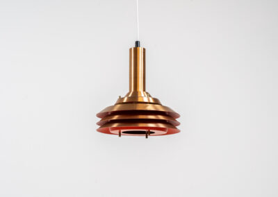 Copper plated Model 705 pendant light by Lyskaer (Denmark, 1960s). This space age beauty contains 4 aluminium shades with a copper colored exterior. The inside is lacquered in orange, which creates a beautiful and warm light dispersion. Newly rewired and in very good condition.