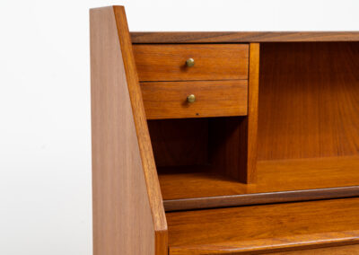 Danish secretary in teak, 1960s. A highly versatile piece featuring beautiful handles, a pull-out leaf and lots of storage space. A small and convenient piece that finds its way in any setting. In very good condition!