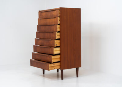 Danish tallboy chest of drawers in teak, 1960s. It contains 8 drawers with beautiful sculpted handles. The teak has a very nice and warm woodgrain. In good condition with normal traces of age and one repair spot.