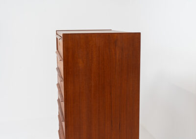Danish tallboy chest of drawers in teak, 1960s. It contains 8 drawers with beautiful sculpted handles. The teak has a very nice and warm woodgrain. In good condition with normal traces of age and one repair spot.