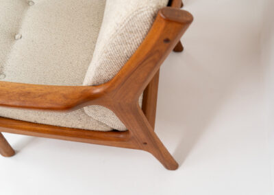 Stunning easy chair by Gustav Thams for A/S Vejen (Denmark, 1960s). The rounded and organic shapes on this one is just impressive. It features a solid teak frame and the original beige upholstery. It seems to us that its not even been used, as the condition of the wood and the fabric is perfect.  