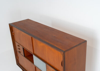 Beautiful and organic Danish highboard, 1960s. A very functional piece with lots of storage space and a wonderful organic shape. It contains four sliding doors, two glass sliding doors and some small drawers. In very good condition with some minor using traces.