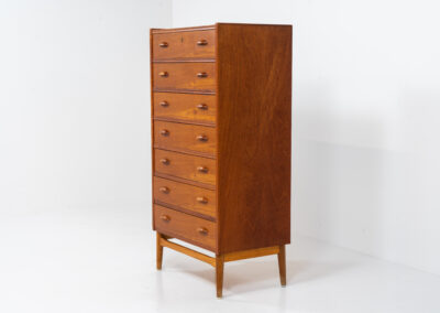 Amazing tallboy dresser by Johannes Sorth for Nexø Møbelfabrik (Denmark, 1960s). An outstanding high quality piece with 7 convenient drawers and nice organic sculpted handles. It’s finished in a teak veneer with a nice woodgrain and stands on a solid oak frame. In very good condition! Ideal dimensions.
