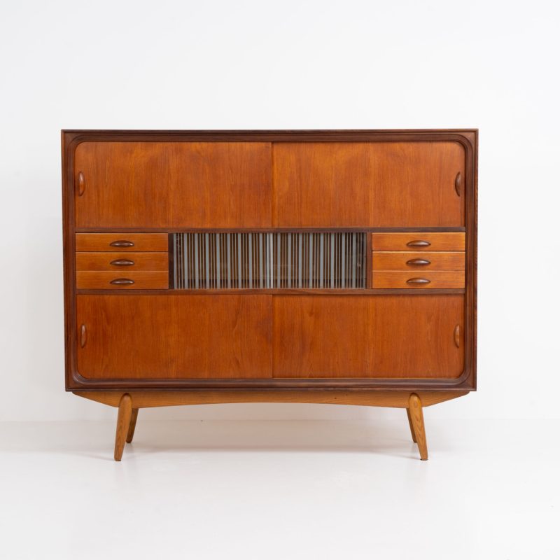 Beautiful and organic Danish highboard, 1960s. A very functional piece with lots of storage space and a wonderful organic shape. It contains four sliding doors, two glass sliding doors and some small drawers. In very good condition with some minor using traces.