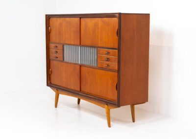 Beautiful and organic Danish highboard, 1960s. A very functional piece with lots of storage space and a wonderful organic shape. It contains four sliding doors, two glass sliding doors and some small drawers. In very good condition with some minor using traces.