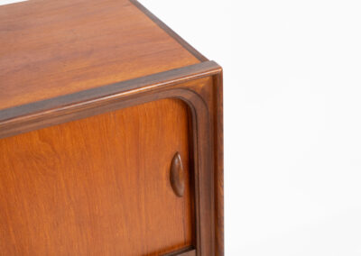 Beautiful and organic Danish highboard, 1960s. A very functional piece with lots of storage space and a wonderful organic shape. It contains four sliding doors, two glass sliding doors and some small drawers. In very good condition with some minor using traces.