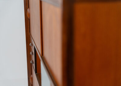 Beautiful and organic Danish highboard, 1960s. A very functional piece with lots of storage space and a wonderful organic shape. It contains four sliding doors, two glass sliding doors and some small drawers. In very good condition with some minor using traces.