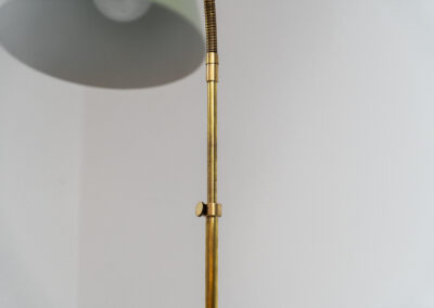 Early model of the “Bellevue AJ7” floor lamp by Arne Jacobsen (Denmark, 1929). This early model of the Bellevue series, made with a solid brass stand, is extremely rare to find. It was designed for “The house of the future” exhibition in Copenhagen in 1929. It is adjustable in height and angle. This piece is fully restored and in amazing condition. The brass has a very nice patina.