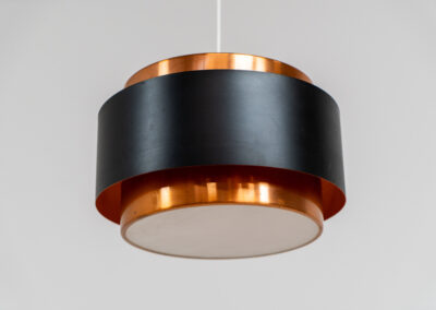 Stunning Saturn pendant light by Jo Hammerborg for Fog & Mørup (Denmark, 1960s). A stunning design with a beatutiful contrast between copper and matte black. At the top and the bottom, the lamp is closed by two acrylic plates that create an anti-dazzle and glare-free effect. A high end piece, made with quality materials. In very good condition! It features the original Fog & Mørup lable inside.