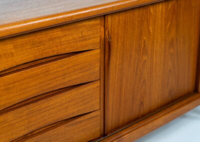 Sideboard by Gunni Omann for Axel Christensen, ACO (Denmark, 1960s). A wonderful teak sideboard with a lot of details and organic finishes. The drawers and handles on this one are just amazing. A high quality Danish piece in very good condition. It has some minor traces of age and use.