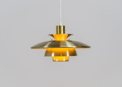 Brass colored pendant light by Lyskaer (Denmark, 1970s). A beautiful lamp made out of four aluminium shades with a brass colored exterior. Newly rewired and in very good condition. Labeled by maker.