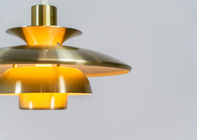 Brass colored pendant light by Lyskaer (Denmark, 1970s). A beautiful lamp made out of four aluminium shades with a brass colored exterior. Newly rewired and in very good condition. Labeled by maker.