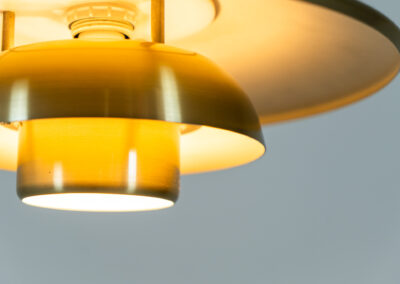 Brass colored pendant light by Lyskaer (Denmark, 1970s). A beautiful lamp made out of four aluminium shades with a brass colored exterior. Newly rewired and in very good condition. Labeled by maker.