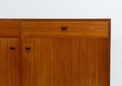 Teak sideboard by Brouer Møbel (Denmark, 1960s). A nice and convenient piece featuring two doors with adjustable shelves on the inside and two drawers. It has a beautiful warm woodgrain. In very good condition!