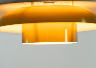 Brass colored pendant light by Frandsen (Denmark, 1970s). A beautiful lamp made out of four aluminium shades with a brass colored exterior. Newly rewired and in very good condition. Labeled by maker.