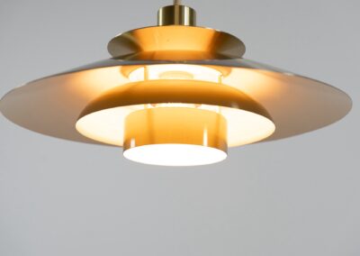 Brass colored pendant light by Frandsen (Denmark, 1970s). A beautiful lamp made out of four aluminium shades with a brass colored exterior. Newly rewired and in very good condition. Labeled by maker.
