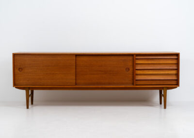 Exceptional sideboard from the Platon series by Lothar Wegner (Germany, 1960s). This is one of our favorite sideboards! The combination of the sleek lines and the organic drawers is just amazing. It has subtle round inset handles and a beautiful warm woodgrain. Featuring two big sliding doors, three drawers and lots of storage space. In very good condition!