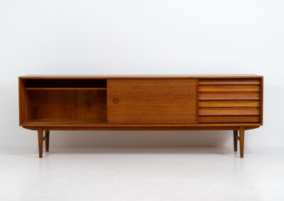 Exceptional sideboard from the Platon series by Lothar Wegner (Germany, 1960s). This is one of our favorite sideboards! The combination of the sleek lines and the organic drawers is just amazing. It has subtle round inset handles and a beautiful warm woodgrain. Featuring two big sliding doors, three drawers and lots of storage space. In very good condition!