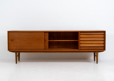 Exceptional sideboard from the Platon series by Lothar Wegner (Germany, 1960s). This is one of our favorite sideboards! The combination of the sleek lines and the organic drawers is just amazing. It has subtle round inset handles and a beautiful warm woodgrain. Featuring two big sliding doors, three drawers and lots of storage space. In very good condition!