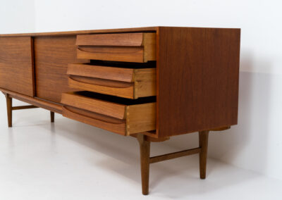 Exceptional sideboard from the Platon series by Lothar Wegner (Germany, 1960s). This is one of our favorite sideboards! The combination of the sleek lines and the organic drawers is just amazing. It has subtle round inset handles and a beautiful warm woodgrain. Featuring two big sliding doors, three drawers and lots of storage space. In very good condition!
