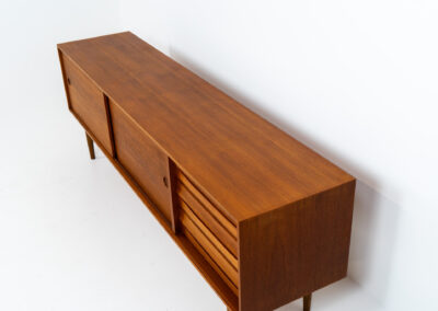 Exceptional sideboard from the Platon series by Lothar Wegner (Germany, 1960s). This is one of our favorite sideboards! The combination of the sleek lines and the organic drawers is just amazing. It has subtle round inset handles and a beautiful warm woodgrain. Featuring two big sliding doors, three drawers and lots of storage space. In very good condition!