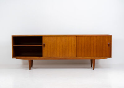 Teak sideboard by Clausen & Son (Denmark, 1960s). It features 2 sliding doors, adjustable shelves inside, 4 central drawers and nice sculptural handles. A high quality masterpiece in splendid condition! Marked by maker on the back.