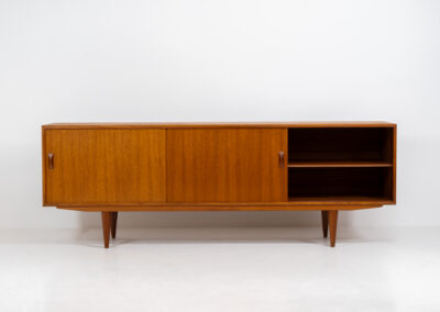 Teak sideboard by Clausen & Son (Denmark, 1960s). It features 2 sliding doors, adjustable shelves inside, 4 central drawers and nice sculptural handles. A high quality masterpiece in splendid condition! Marked by maker on the back.