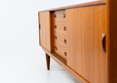 Teak sideboard by Clausen & Son (Denmark, 1960s). It features 2 sliding doors, adjustable shelves inside, 4 central drawers and nice sculptural handles. A high quality masterpiece in splendid condition! Marked by maker on the back.