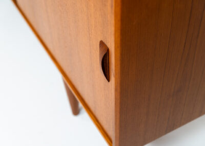 Teak sideboard by Clausen & Son (Denmark, 1960s). It features 2 sliding doors, adjustable shelves inside, 4 central drawers and nice sculptural handles. A high quality masterpiece in splendid condition! Marked by maker on the back.