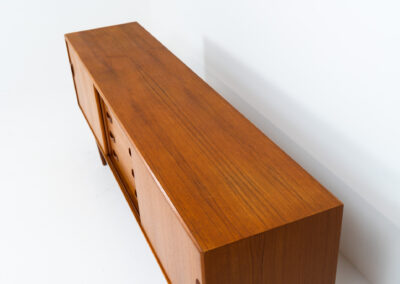 Teak sideboard by Clausen & Son (Denmark, 1960s). It features 2 sliding doors, adjustable shelves inside, 4 central drawers and nice sculptural handles. A high quality masterpiece in splendid condition! Marked by maker on the back.