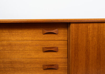 Teak sideboard by Clausen & Son (Denmark, 1960s). It features 2 sliding doors, adjustable shelves inside, 4 central drawers and nice sculptural handles. A high quality masterpiece in splendid condition! Marked by maker on the back.