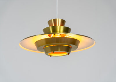 Brass colored pendant light (Denmark, 1970s). We don’t know who made this one but it’s definitely a beautiful piece! Parts of the inside are lacquered in orange which gives a nice effect when turned on. In very good condition with some minor scratches.