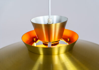 Brass colored pendant light (Denmark, 1970s). We don’t know who made this one but it’s definitely a beautiful piece! Parts of the inside are lacquered in orange which gives a nice effect when turned on. In very good condition with some minor scratches.
