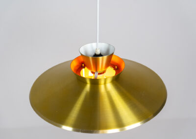 Brass colored pendant light (Denmark, 1970s). We don’t know who made this one but it’s definitely a beautiful piece! Parts of the inside are lacquered in orange which gives a nice effect when turned on. In very good condition with some minor scratches.