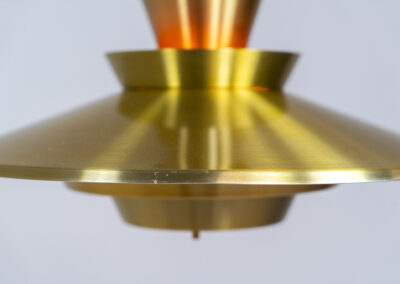 Brass colored pendant light (Denmark, 1970s). We don’t know who made this one but it’s definitely a beautiful piece! Parts of the inside are lacquered in orange which gives a nice effect when turned on. In very good condition with some minor scratches.