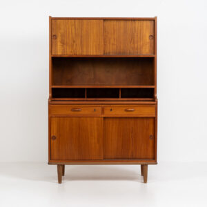 Teak secretary/bookcase by Harald Nielsen (Denmark, 1960s). A nicely designed and multifunctional piece containing four sliding doors, two drawers, a convenient pull-out leaf and some open storage space. Featuring nice handles and a warm natural wood grain. It is in splendid condition and the original key is included.