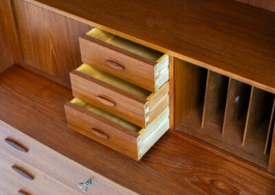 Stunning secretary with tambour doors by Storgaard Nielsen Møbelfabrik (Denmark, 1960s). It looks absolutely amazing! This teak secretary is a highly versatile piece featuring beautiful handles, a pull-out leaf, lots of storage space and beautiful hidden tambour doors. It’s in very good condition with some minor traces of age and use.