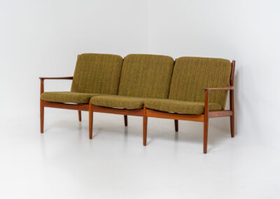 Impressive 3-seater sofa by Grete Jalk for Glostrup (Denmark, 1960s). What an eye catcher.. it features a solid teak frame which is beautifully sculpted and the original cushions! The green/yellow wool fabric is original aswell and remains in amazing condition. Obviously an example of true Scandinavian craftsmanship. It is a pleasure for the eyes and a pleasure to sit in! Marked by maker.