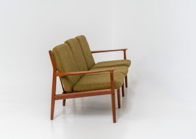 Impressive 3-seater sofa by Grete Jalk for Glostrup (Denmark, 1960s). What an eye catcher.. it features a solid teak frame which is beautifully sculpted and the original cushions! The green/yellow wool fabric is original aswell and remains in amazing condition. Obviously an example of true Scandinavian craftsmanship. It is a pleasure for the eyes and a pleasure to sit in! Marked by maker.